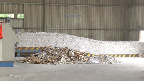Bales-of-shredded-paper,-pile-of-paper-waste-in-recycling-plant