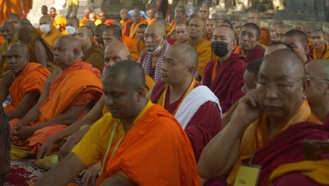 Buddhist-monks-assembly-on-the-occasion-of-Holy-Dalai-88th-birthday-at-the-sacred-Mahabodhi-Temple-World-Heritage-site,-Closeup-shot
