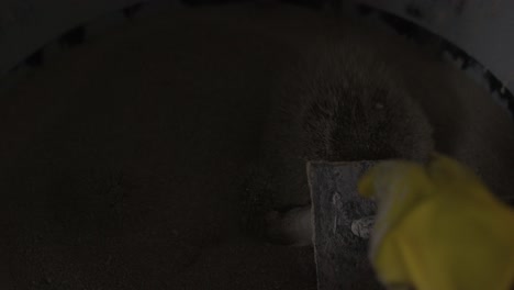 Slow-motion-above-scene-of-prepared-wax-mold-being-soaked-in-sand-which-is-dry