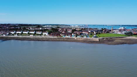 Lighthouse-Museum,-countless-houses,-and-beach-huts-stretch-along-the-shore-and-are-visible-from-the-sea