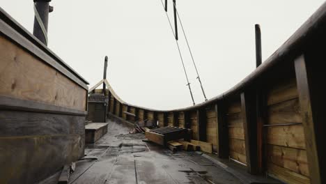 Walking-on-Traditional-Wooden-Viking-Boat-Deck-Replica,-Low-Angle