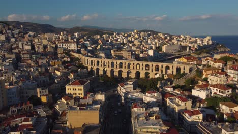 Aerial-establishing-over-ancient-Roman-aqueduct-in-Kavala,-Greece-at-sunset