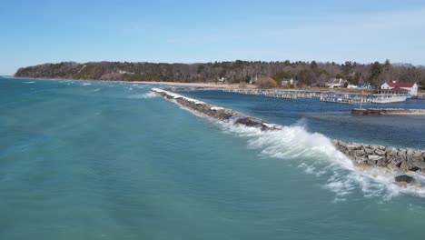Waves-of-Michigan-lake-hitting-Leland,-aerial-drone-view