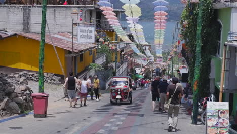 Umbrellas-hang-over-steep-cobble-tourist-street-in-San-Juan-la-Laguna