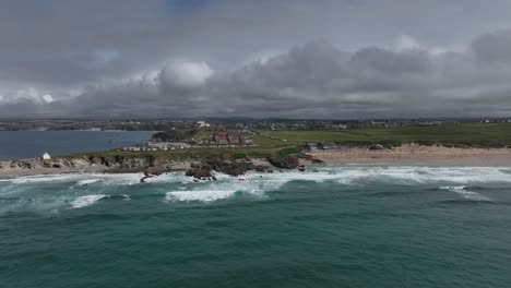 Establishing-shot-showing-the-Headland-Hotel-and-a-busy-Fistral-beach,-Newquay