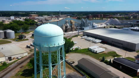 Aerial-view-around-a-light-blue-watertower,-sunny,-summer-day-in-Greenbay,-USA