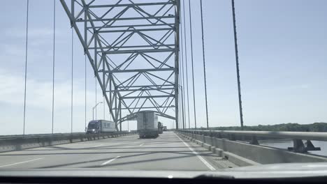 driving-plate,-front-view-of-vehicle-under-metal-structure,-bridge