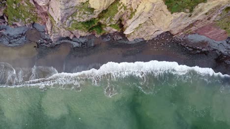 Luftaufnahme-Mit-Schwenk-Links-Vom-Strand-Und-Ankommenden-Gezeiten-An-Der-Copper-Coast,-Waterford,-Irland