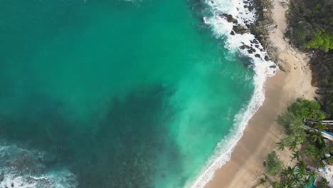Above-the-blue,-drone's-eye-view-of-Coral-beach's-crystal-clear-at-Puerto-Escondido,-Oaxaca,-Mexico