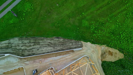 Overhead-Drone-Perspective-of-a-Modern-Factory-Under-Construction-Amidst-Verdant-Farmland