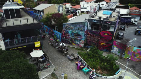 Aerial-overview-of-graffiti-and-a-restaurant-at-the-Batman-Alley,-in-cloudy-Vila-Madalena,-Sao-Paulo,-Brazil