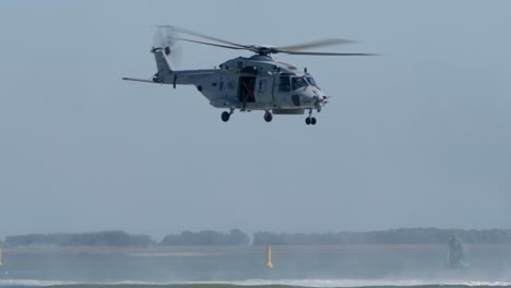 NH-90-Helicopter-Flying-Low-Above-the-Sea,-Winchman-Standing-in-Door