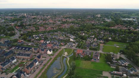 Drone-shot-of-a-residential-area-of-the-city-of-Nijkerk-in-the-Netherlands-with-a-nature-park