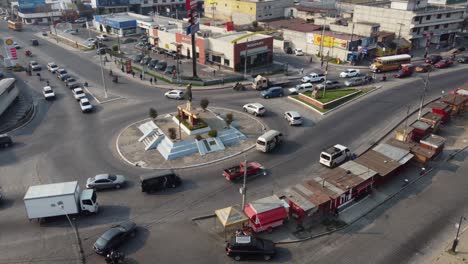 Aerial-orbits-street-traffic-roundabout-in-Quetzaltenango-Guatemala