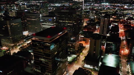 Aerial-view-over-illuminated-high-rise-in-Denver-city,-night-in-Colorado,-USA