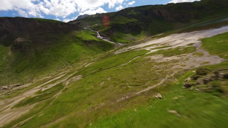 Low-altitude-flight-over-a-green-valley-on-a-summer-day-at-Grossglockner-alpine-road-in-Austria