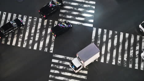 Traffic-driving-over-the-famous-Shibuya-crossing,-in-Tokyo,-Japan---static-view