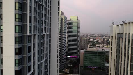Bangkok-urban-aerial-flies-close-to-Quinn-Ratchada-highrise-building