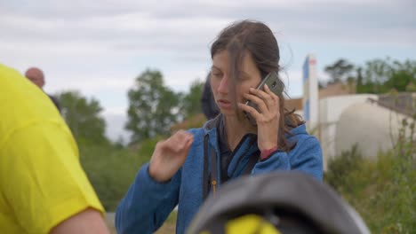 orbiting-shot-of-an-event-organizer-making-phonecalls-for-the-Narbonne-Handicapped-Race