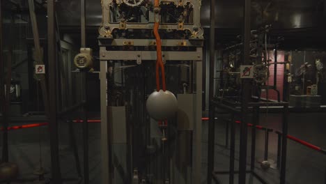 Historic-pendulum-clock-on-display-Inside-National-Technical-Museum-in-Prague,-Czech-Republic,-static-shot