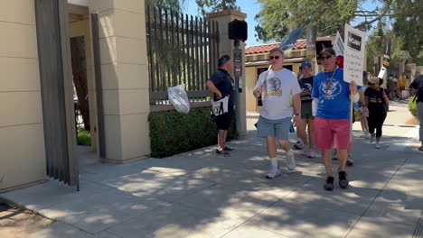 WGA-and-SAG-AFTRA-Strikers-Picketing-Outside-Warner-Brothers-Studio-with-Children-in-Stroller-on-W-Olive-Ave