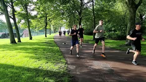 Eine-Gruppe-Von-Menschen-In-Zeitlupe-Läuft-Gemeinsam-Beim-Benefiz-Ausdauermarathon-Im-Schattigen-öffentlichen-Park