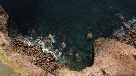topdown-view-of-Rocky-coastline-with-fog-in-the-Portugal-Southeast