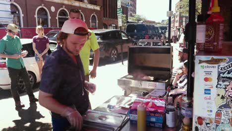 Vendedor-Ambulante-Preparando-Hot-Dogs-Para-Los-Clientes