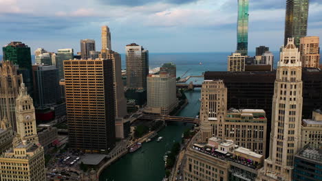 Aerial-view-over-the-riverwalk,-toward-lake-Michigan,-sunset-in-Chicago,-USA