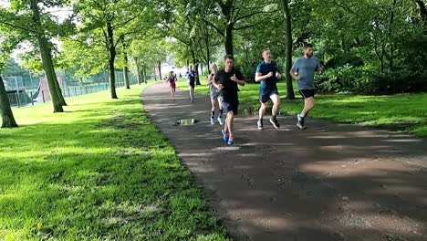 Slow-motion-various-sporty-friends-running-in-charity-marathon-in-shaded-public-park