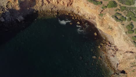 Von-Oben-Nach-Unten-Kreisende-Aufnahme-Der-Felsigen-Küste-Im-Südosten-Portugals