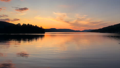 Sunset-over-the-water-and-mountains-of-Lake-Tremblant-in-Mont-Tremblant,-Quebec