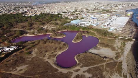 Pink-Lake-next-to-town-in-Africa,-Senegal,-Joal-Fadiouth