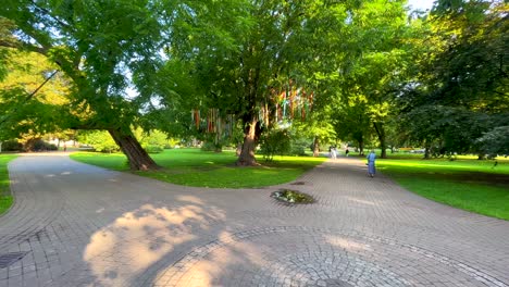 People-walking-in-Vermanes-Garden-central-parc-in-Riga-Latvia-during-summer