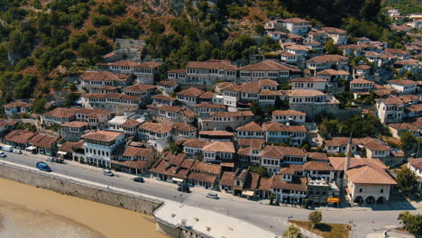 Berat-Albania,-aerial-views-of-the-cityscape:-crane-shot-of-the-famous-houses-with-their-dwellings-full-of-windows