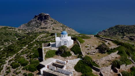 Aerial-View-Coming-Down-To-Isolated-Hilltop-Church-In-Vroutsi