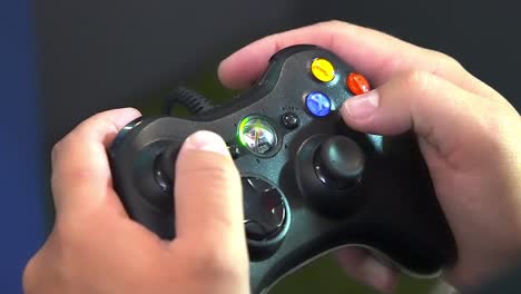 Gamer's-hand-maneuvers-and-play-Xbox-controller,-over-the-shoulder-handheld-close-up-shot