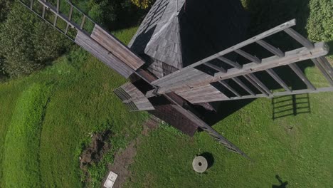 A-historic-wooden-mill-within-a-European-open-air-museum,-captured-during-the-summer-season-in-dynamic-4K-drone-footage
