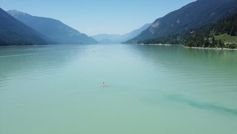 A-Person-Is-Paddle-Boarding-Over-Lillooet-Lake-In-Squamish-Lillooet,-British-Columbia,-Canada
