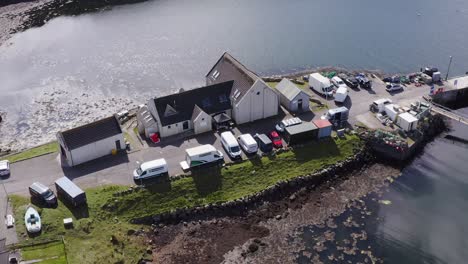Dynamic-drone-shot-of-the-community-centre-on-the-Isle-of-Scalpay,-an-island-near-the-Isles-of-Harris-and-Lewis-on-the-Outer-Hebrides-of-Scotland