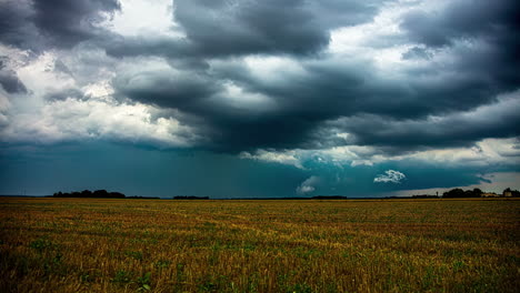 Dark-storm-clouds-form-as-farmers-harvest-their-crops---time-lapse