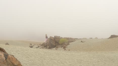 Woman-walking-over-the-mist-at-Teide-National-Park,-static