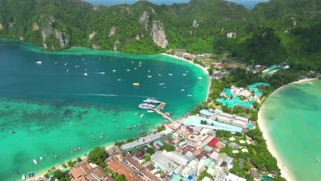 Busy-lagoon-on-famous-vacation-island-Koh-Phi-Phi-in-Thailand,-aerial-orbit