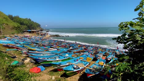 Traditional-blue-indonesian-fishing-boats-on-menganti-beach,-Indonesia