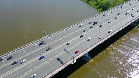 Aerial-view-of-traffic-moving-on-a-massive-bridge-over-the-Vistula-River-in-Warsaw