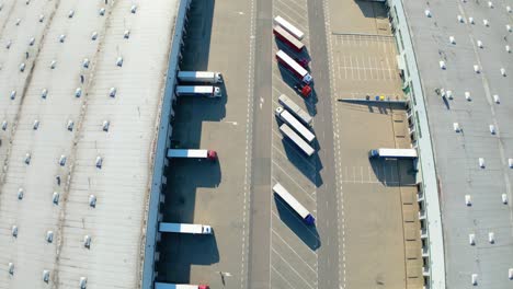 Aerial-view-of-distribution-center,-drone-photo-of-industrial-logistics-zone,new-super-modern-logistics-center-full-of-modern-technology-and-robotics,roof-solar-power-plant-for-green-energy-production