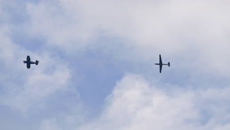 Silhouette-of-plane-towing-gilder-against-cloudy-sky,-view-from-bellow