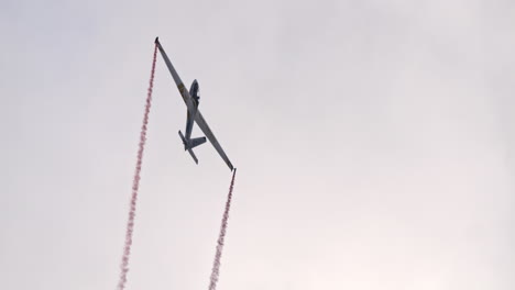 Stunt-pilot-with-Swift-S-1-glider-stall-from-sky-and-fly-away,-handheld-view