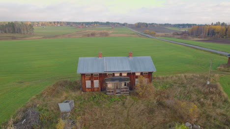 Aerial-footage-of-a-old-abandoned-house-in-the-middle-of-some-farmland