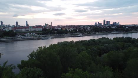 Cinematic-drone-footage-of-Warsaw-skyline-with-vistula-river-and-bridge-filled-with-traffic-with-big-turn-to-reveal-the-city